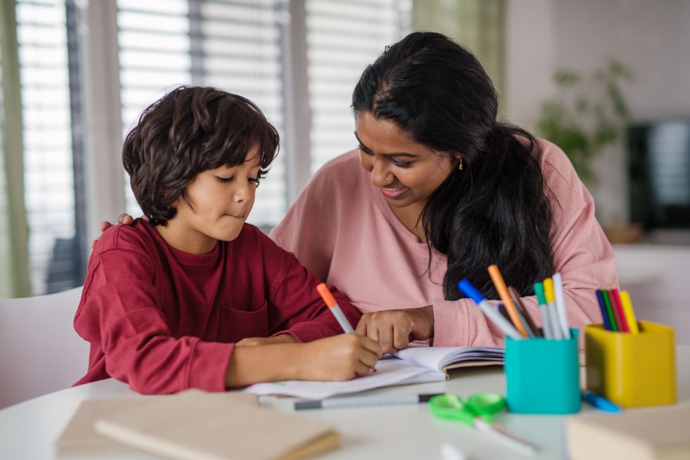 Mother and child sitting together during homeschooling activities