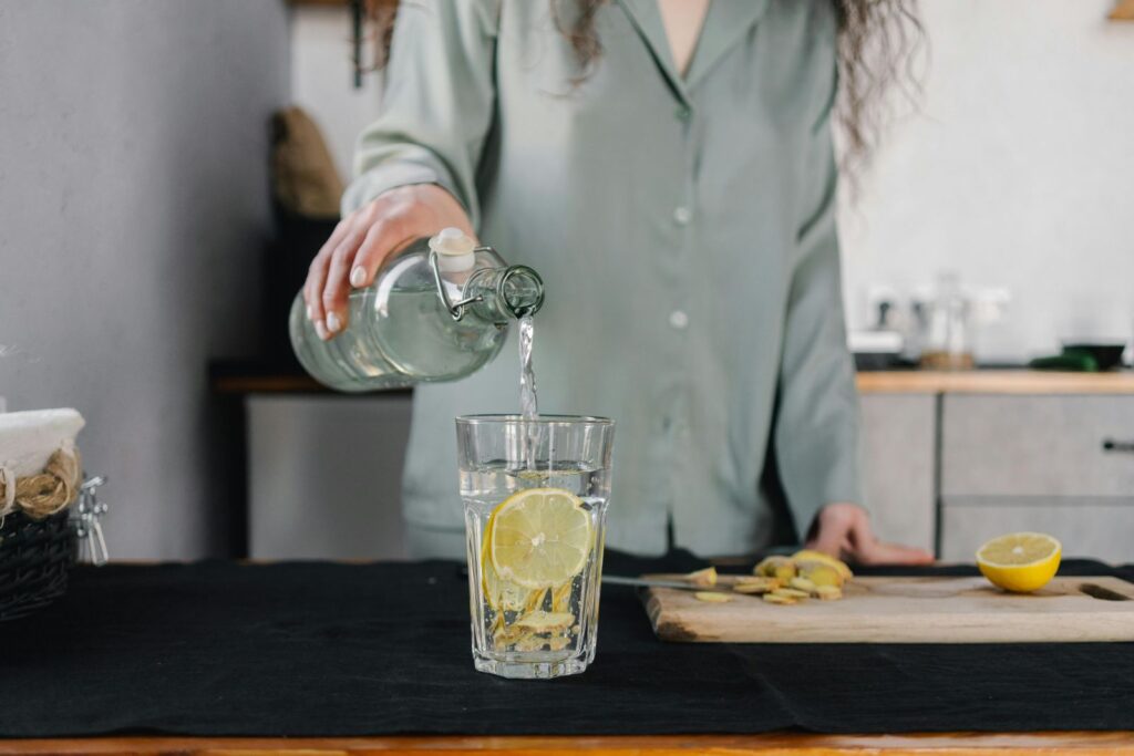 woman pouring water into glass